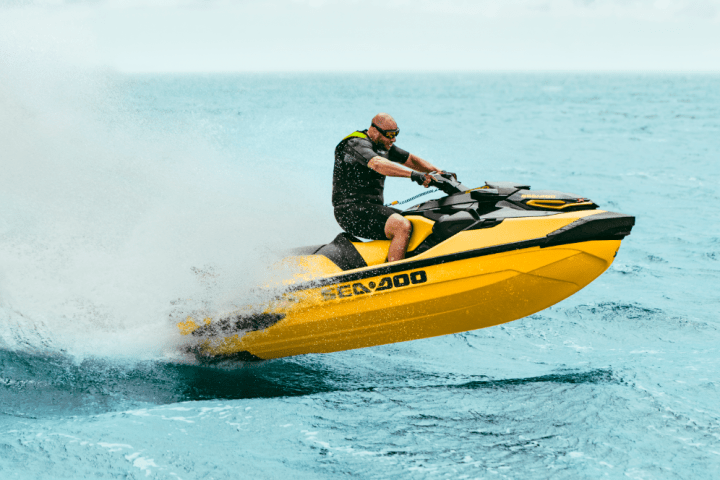 a man riding a wave on a surf board on a body of water
