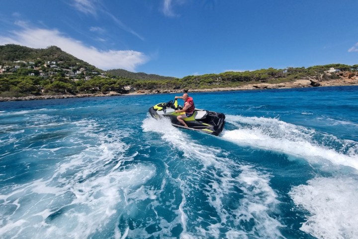 a man riding a wave on top of a body of water