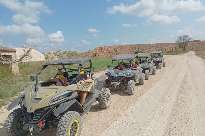 a truck driving down a dirt road