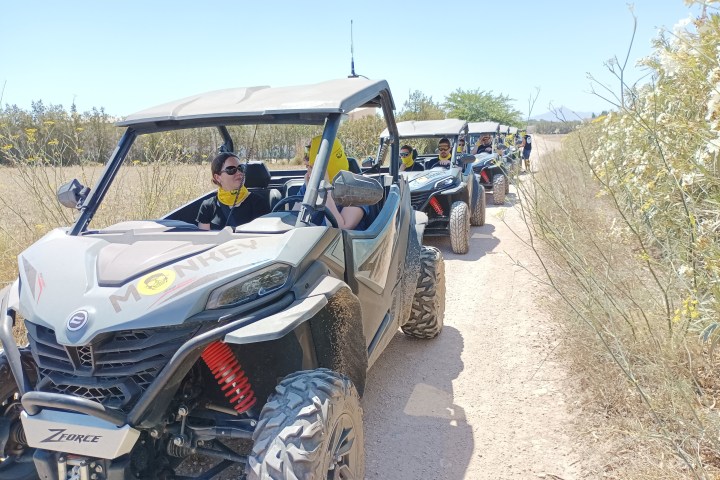 a person riding a motorcycle down a dirt road
